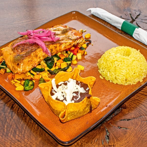 Orale Mexican Restaurant's salmon dish with rice, vegetables, and a tortilla bowl of beans.